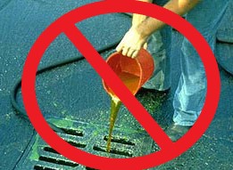 A liquid being poured directly into a drain with a red slash through it.