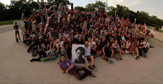 A large group of people posed around a picture of Georgie