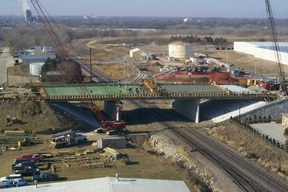 A bridge being built over train tracks