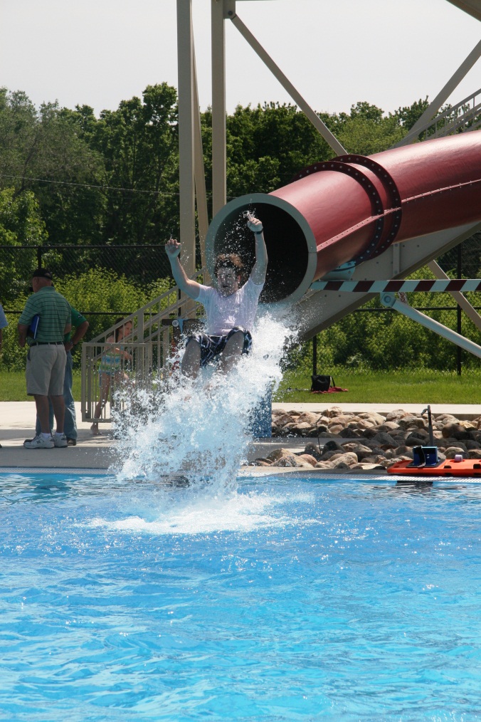 A child coming out of the tube water slide at the Furman Aquatic Center