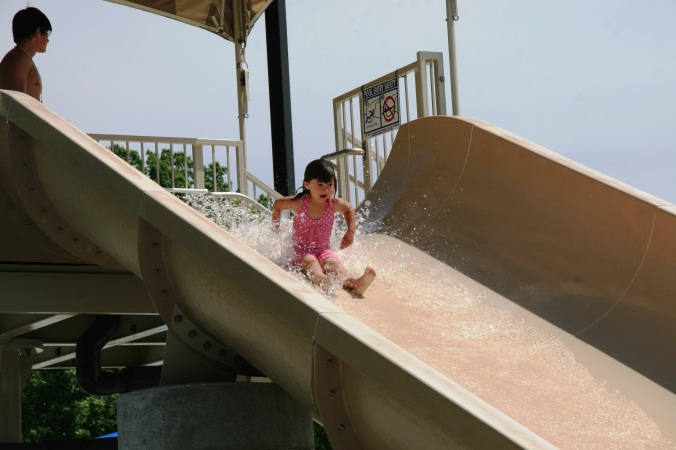 A child going down a water slide at the Furman Aquatic Center