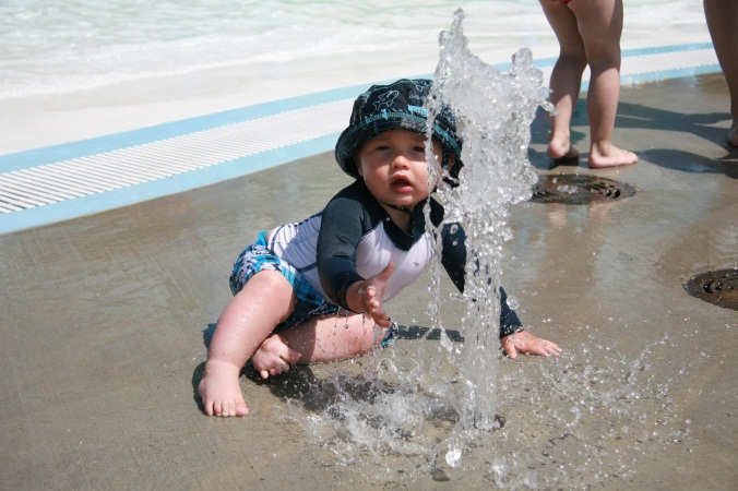 Toddler playing in water at the Aquatic Center