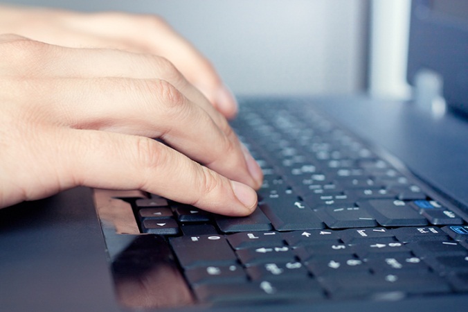 Hand on computer keyboard