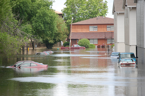 Flood of 2008 showing several cars underwater near apartment buildings in Ames