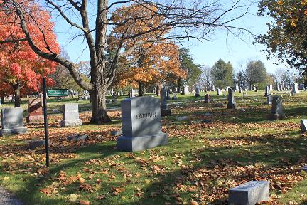 Cemetery section showing monuments and trees with fall colors